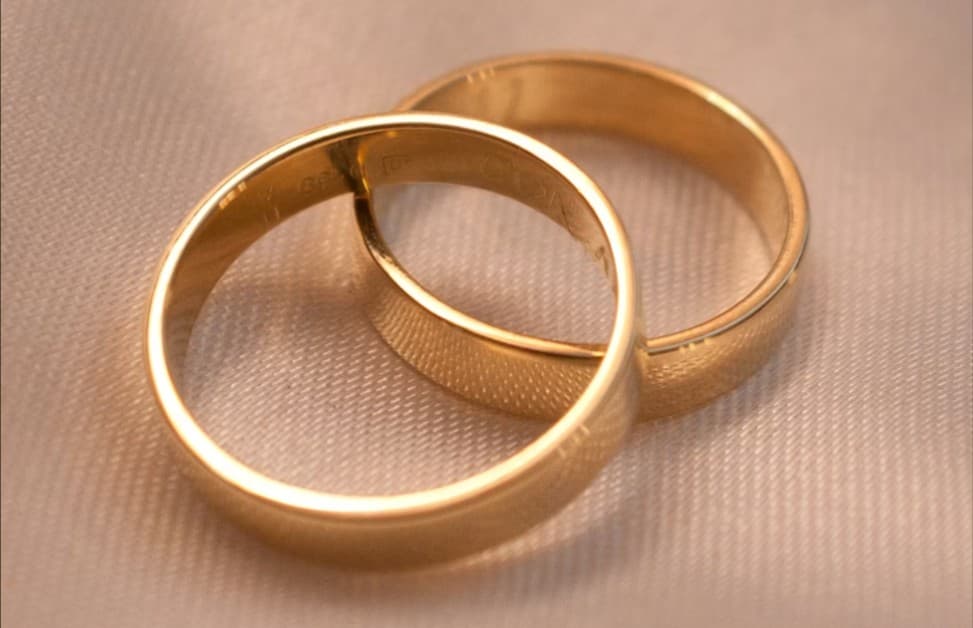 Two gold wedding bands; jewelry repair services available.